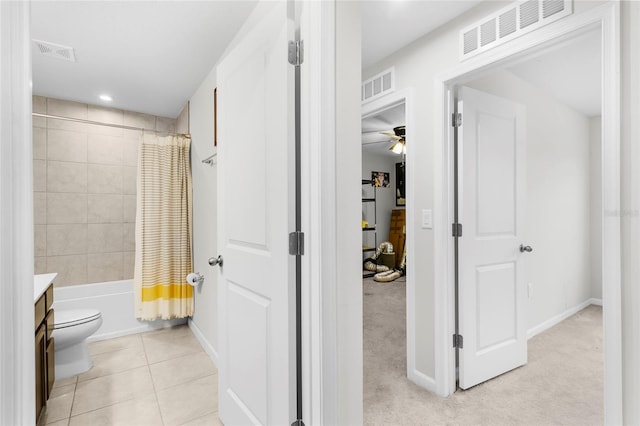 full bathroom featuring vanity, tile patterned flooring, ceiling fan, toilet, and shower / bathtub combination with curtain