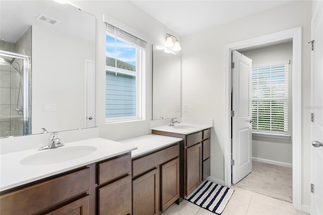 bathroom featuring vanity, tile patterned floors, and a shower with shower door