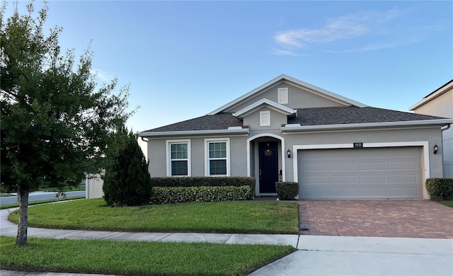 view of front of property featuring a front yard and a garage