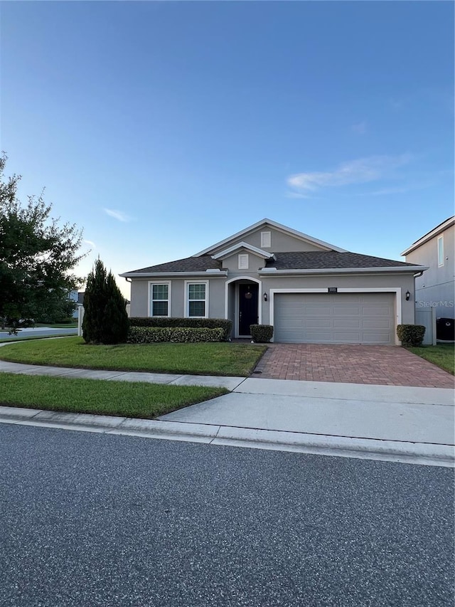 single story home with a front yard and a garage