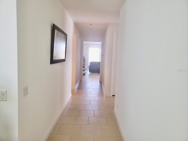 corridor with light tile patterned flooring