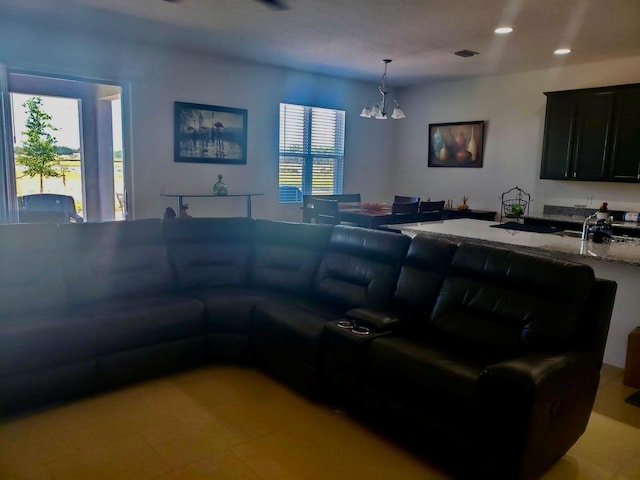 living room featuring a chandelier and sink