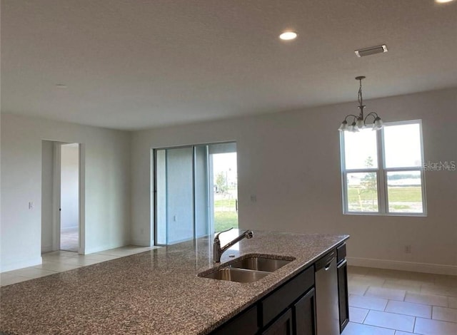 kitchen featuring dishwasher, light tile patterned flooring, light stone countertops, and sink