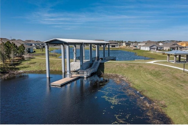 dock area featuring a lawn and a water view