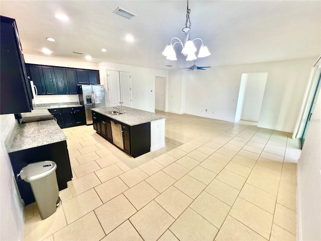 3333 Wauseon Dr, Saint Cloud, FL 34772 - kitchen with stainless steel appliances, a sink, light tile patterned floors, a chandelier, and recessed lighting