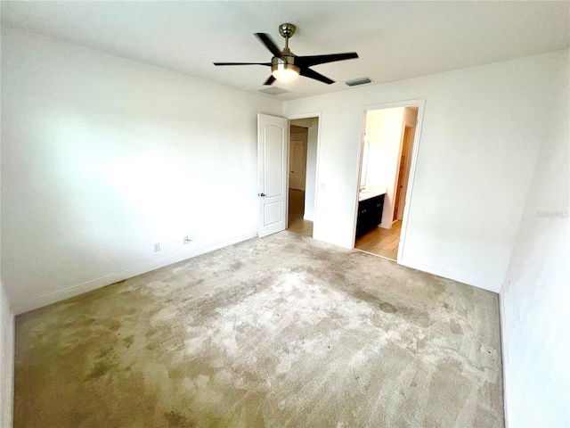 3333 Wauseon Dr, Saint Cloud, FL 34772 - unfurnished bedroom featuring light colored carpet, baseboards, ensuite bath, and a ceiling fan