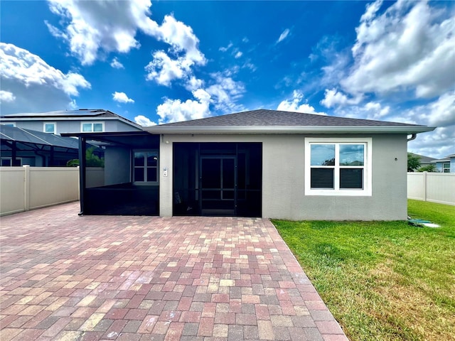 3333 Wauseon Dr, Saint Cloud, FL 34772 - rear view of property featuring a patio area, a sunroom, and stucco siding