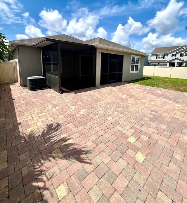 3333 Wauseon Dr, Saint Cloud, FL 34772 - rear view of property with central AC unit, a patio, a sunroom, and stucco siding