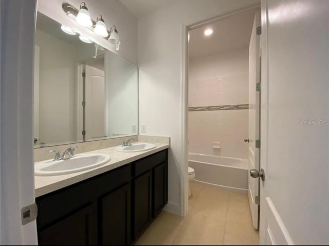 3333 Wauseon Dr, Saint Cloud, FL 34772 - bathroom with toilet, double vanity, tile patterned flooring, recessed lighting, and shower / washtub combination