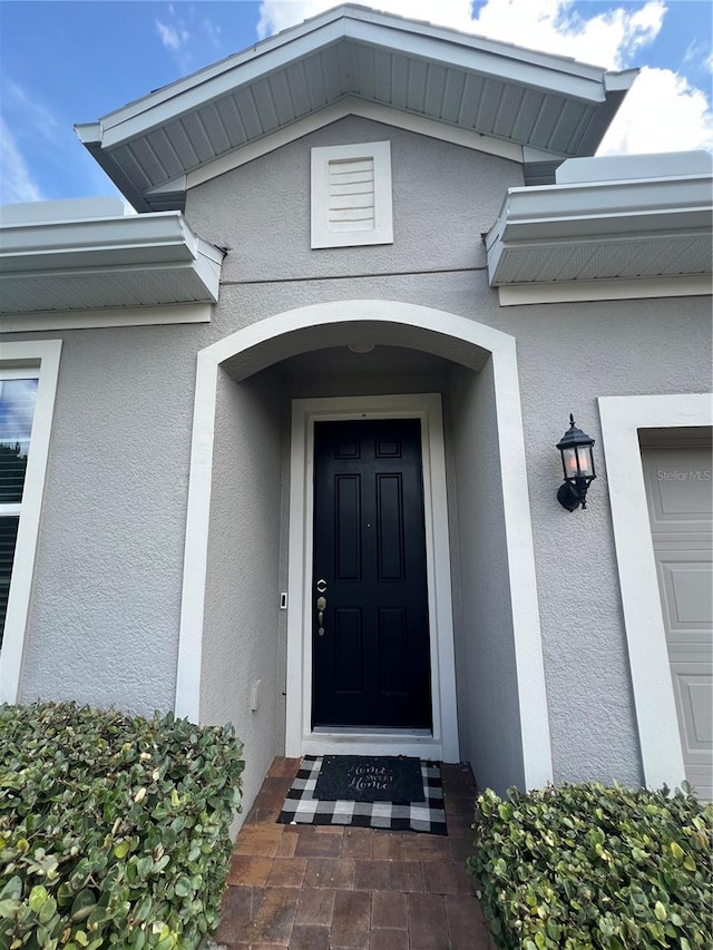 3333 Wauseon Dr, Saint Cloud, FL 34772 - view of exterior entry featuring stucco siding