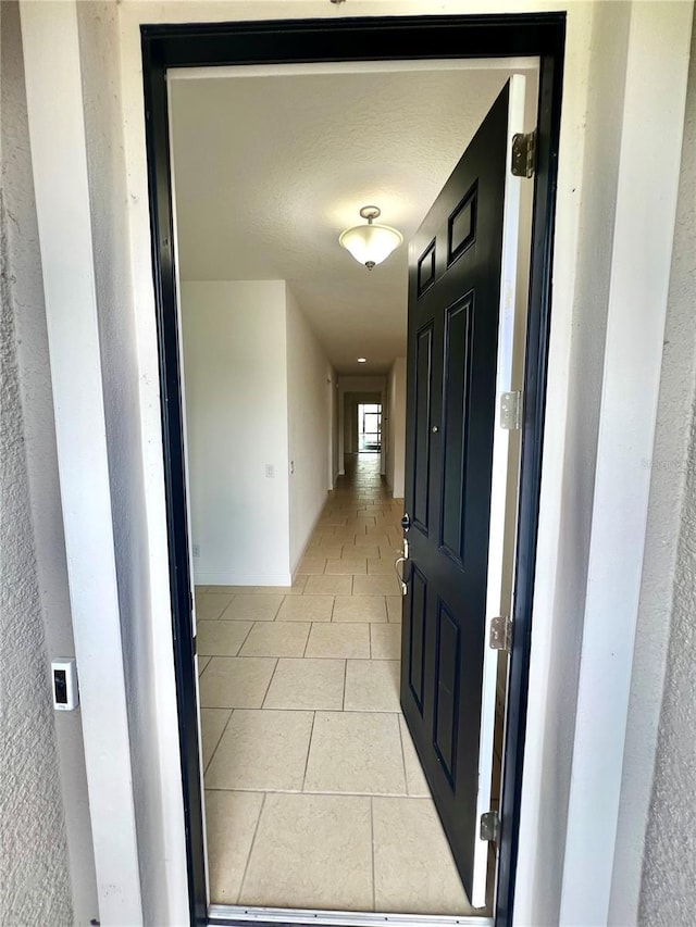 3333 Wauseon Dr, Saint Cloud, FL 34772 - hall featuring light tile patterned flooring and a textured wall