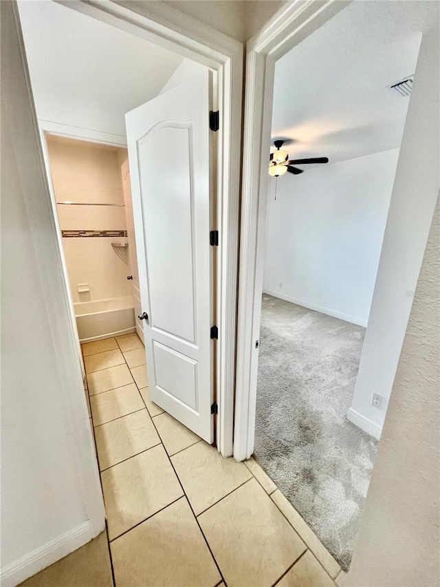 3333 Wauseon Dr, Saint Cloud, FL 34772 - hallway featuring light tile patterned flooring, light colored carpet, and baseboards