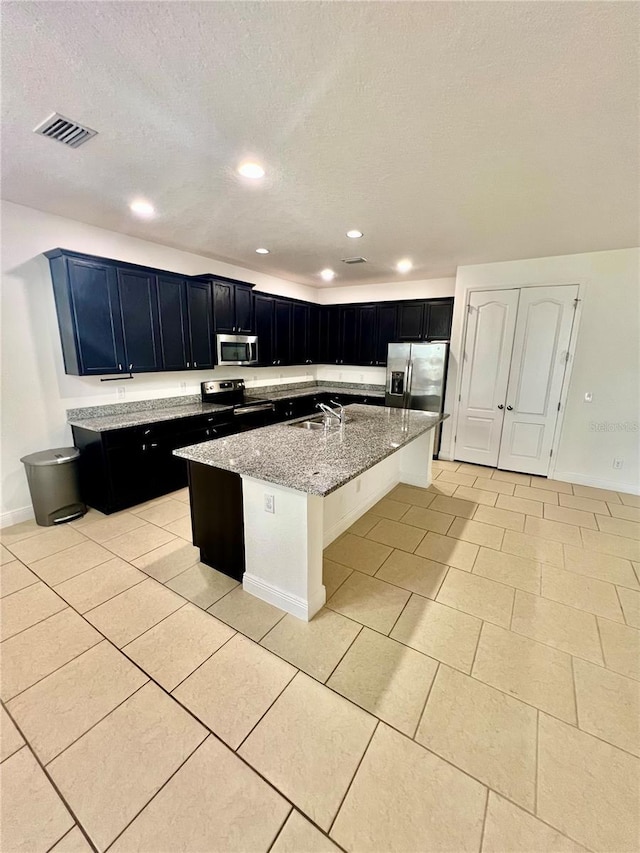 3333 Wauseon Dr, Saint Cloud, FL 34772 - kitchen with stainless steel appliances, a sink, light stone counters, a textured ceiling, and baseboards