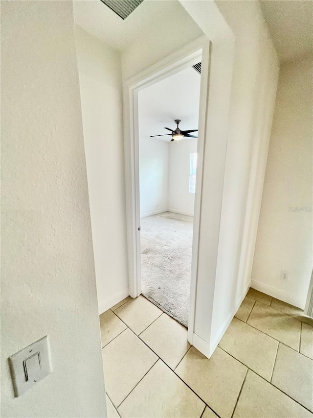 3333 Wauseon Dr, Saint Cloud, FL 34772 - hall with light tile patterned floors, baseboards, and light carpet