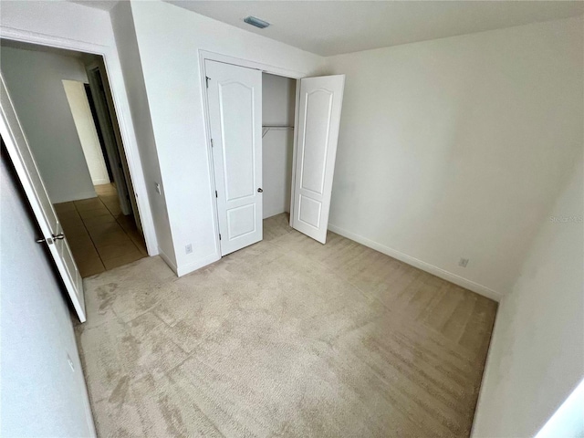 3333 Wauseon Dr, Saint Cloud, FL 34772 - unfurnished bedroom with carpet floors, a closet, and baseboards