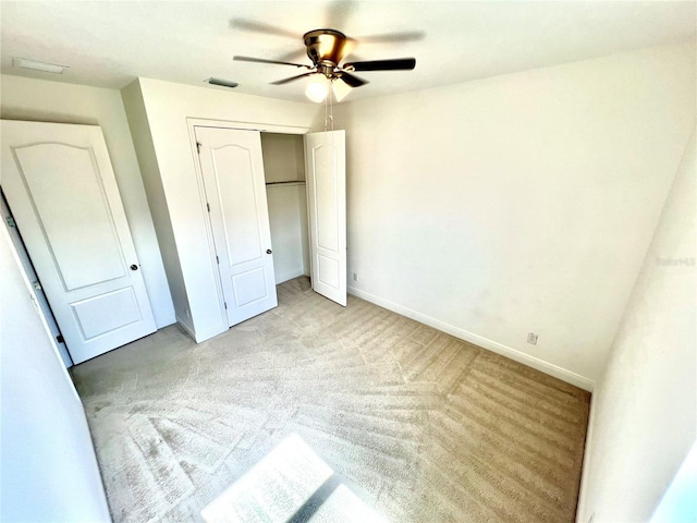 3333 Wauseon Dr, Saint Cloud, FL 34772 - unfurnished bedroom with light colored carpet, baseboards, a closet, and a ceiling fan