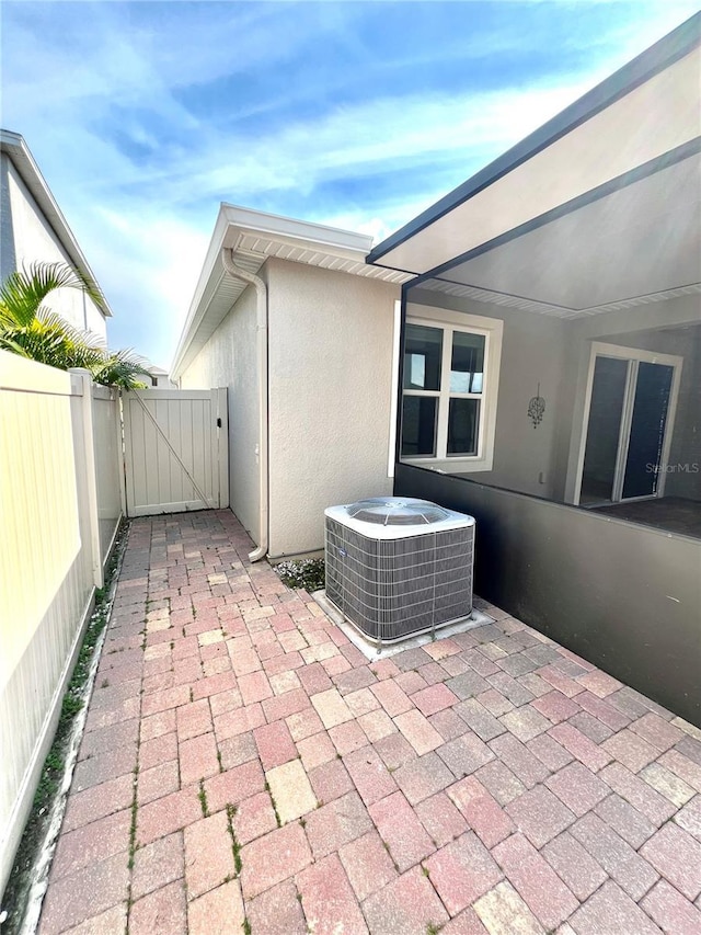 3333 Wauseon Dr, Saint Cloud, FL 34772 - view of patio with central AC unit and a gate