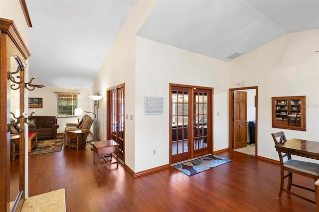 foyer featuring french doors, dark hardwood / wood-style floors, and high vaulted ceiling