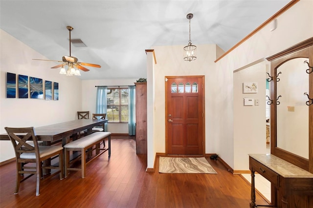 entrance foyer with dark hardwood / wood-style floors and ceiling fan with notable chandelier