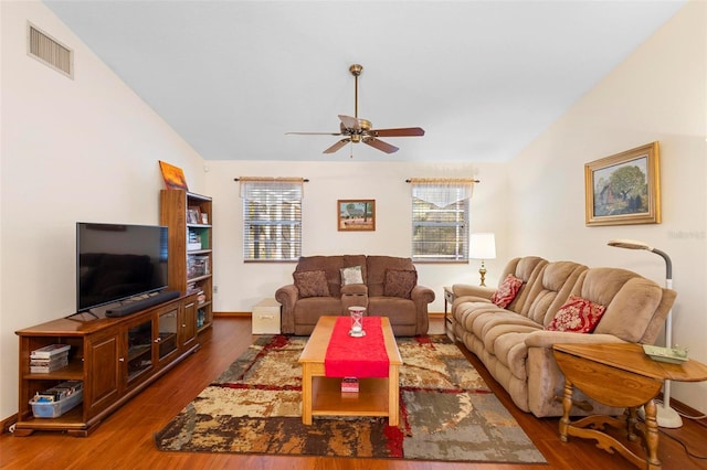 living room with ceiling fan, dark wood-type flooring, and lofted ceiling