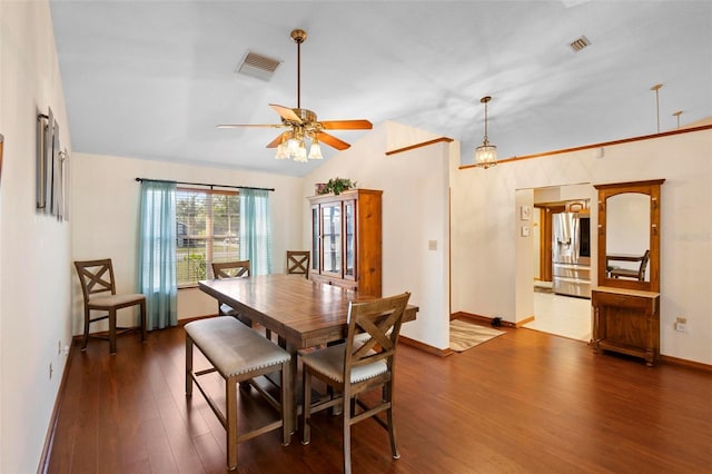 dining area with lofted ceiling, ceiling fan, and dark hardwood / wood-style floors