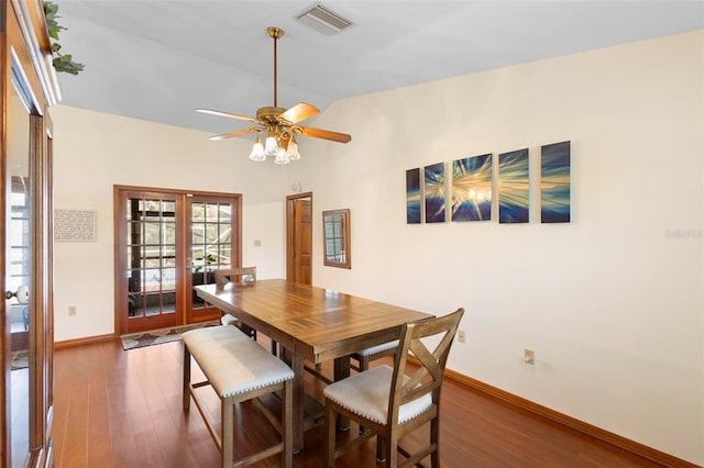 dining space featuring french doors, vaulted ceiling, ceiling fan, and dark wood-type flooring