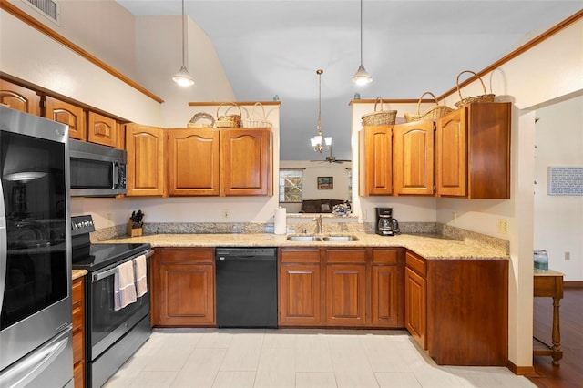 kitchen featuring light stone countertops, sink, stainless steel appliances, pendant lighting, and ceiling fan with notable chandelier