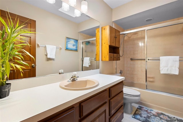 full bathroom with vanity, toilet, and bath / shower combo with glass door