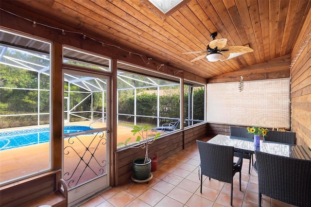 sunroom featuring ceiling fan, lofted ceiling, and wood ceiling