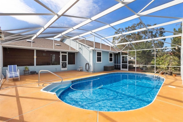 view of swimming pool with a lanai and a patio area