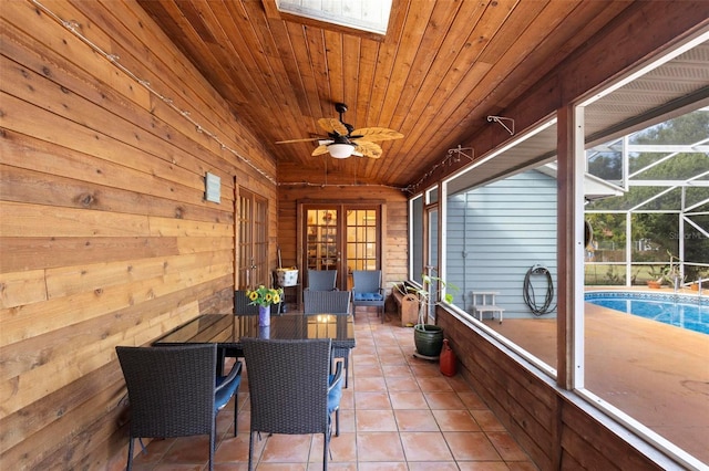 sunroom / solarium with ceiling fan, a swimming pool, and wood ceiling