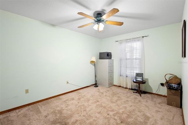 interior space featuring ceiling fan and light carpet