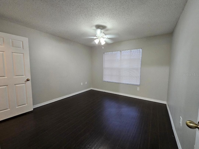 unfurnished room featuring a textured ceiling, ceiling fan, and dark wood-type flooring