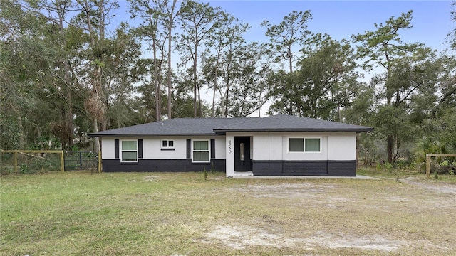 ranch-style home with a front lawn