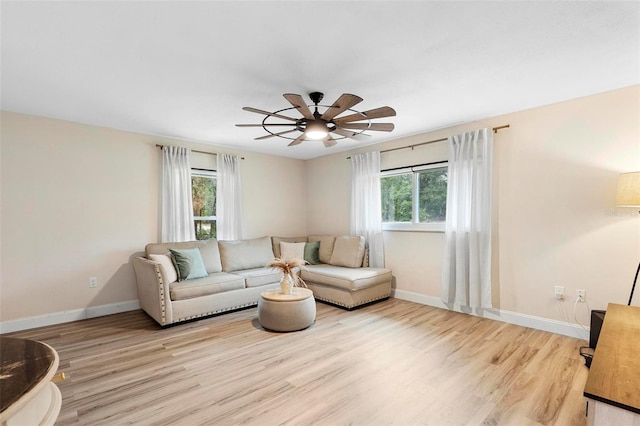 living room featuring ceiling fan and light wood-type flooring