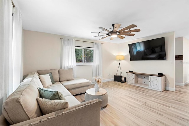 living room featuring ceiling fan and wood-type flooring