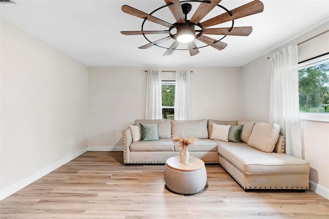 living room featuring light hardwood / wood-style floors and ceiling fan