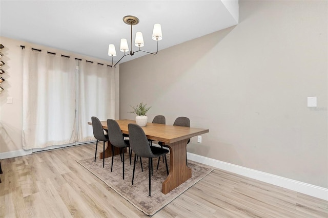 dining room with a notable chandelier and light hardwood / wood-style floors