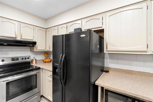 kitchen with black fridge, stainless steel range with electric cooktop, wine cooler, and tasteful backsplash