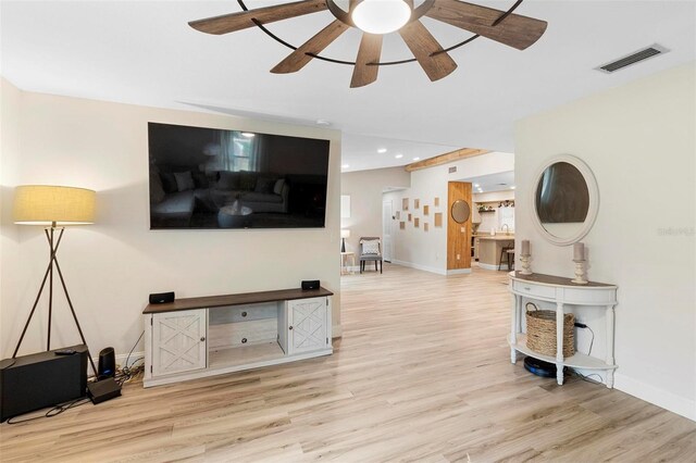 living room with ceiling fan and light hardwood / wood-style floors