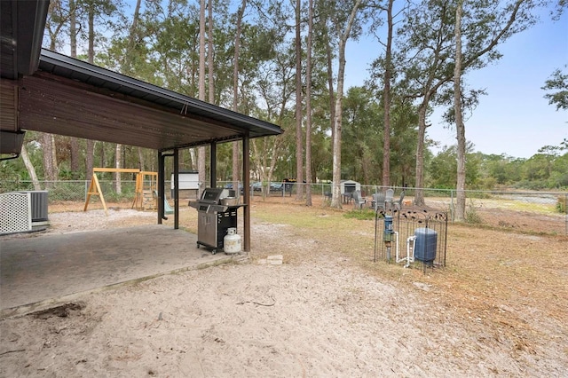 view of yard featuring a playground and central AC unit