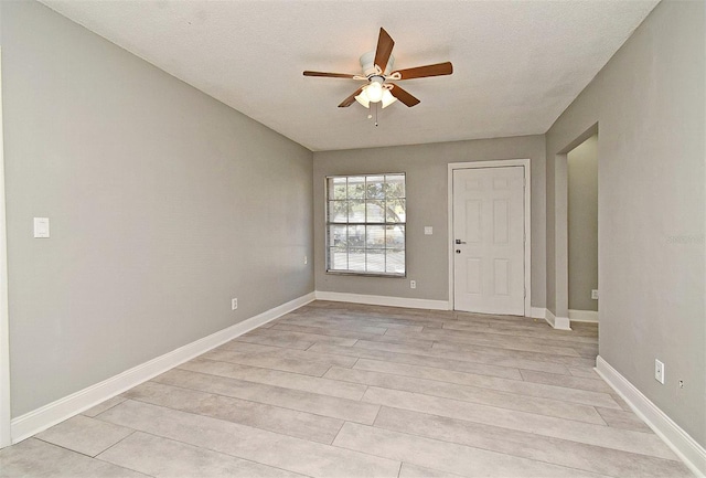 unfurnished room featuring a textured ceiling and ceiling fan