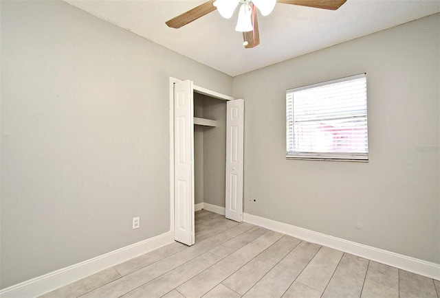 unfurnished bedroom featuring a closet and ceiling fan