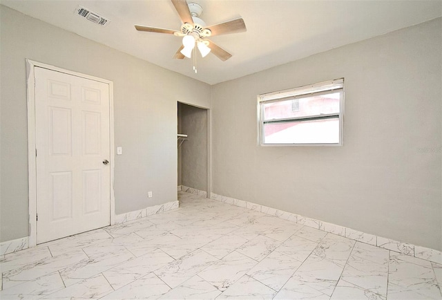 unfurnished bedroom with ceiling fan and a closet