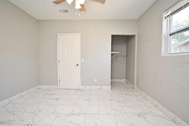 unfurnished bedroom featuring ceiling fan and a closet