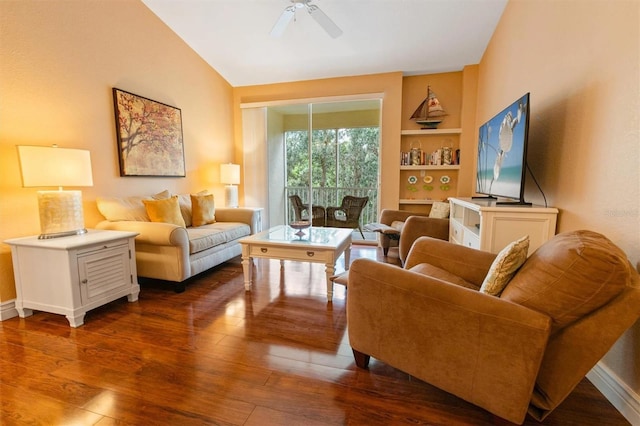 living room with lofted ceiling, built in shelves, ceiling fan, and dark hardwood / wood-style floors