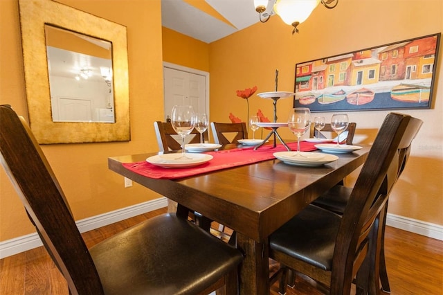 dining space with wood-type flooring