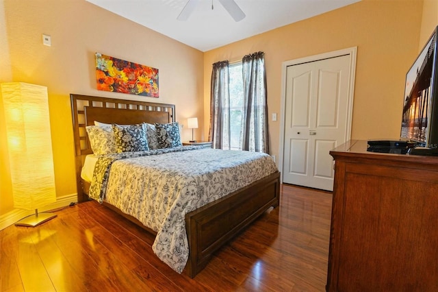 bedroom featuring ceiling fan, a closet, and dark wood-type flooring