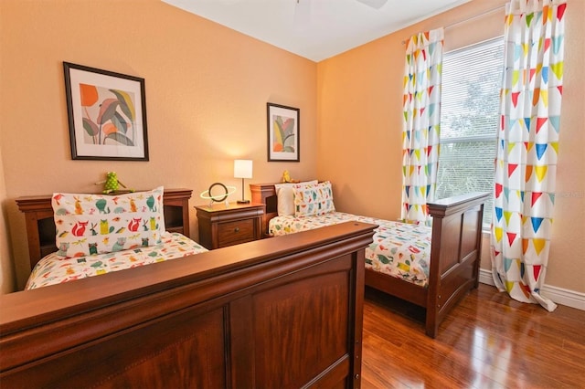 bedroom with wood-type flooring and ceiling fan