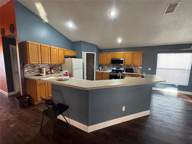 kitchen featuring tasteful backsplash, dark wood-type flooring, an island with sink, and stainless steel appliances